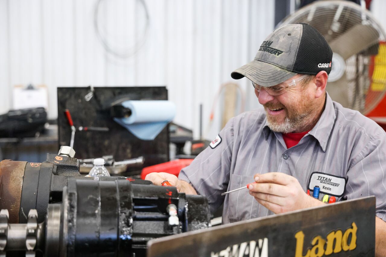 Titan Machinery diesel mechanic working on Case IH farm equipment