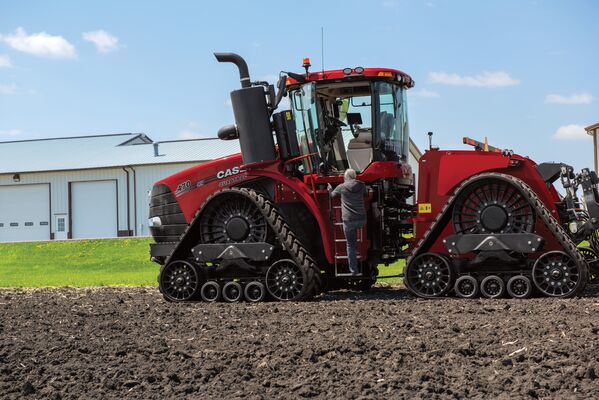 AFS Connect Steiger 470 Tractor in Field with Producer Producer climbing ladder of CIH Steiger 470 with Continental Tracks