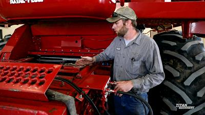Titan Service Technician - Case IH Combine Titan Machinery service tech demonstrating maintenance on a Case IH 2388
