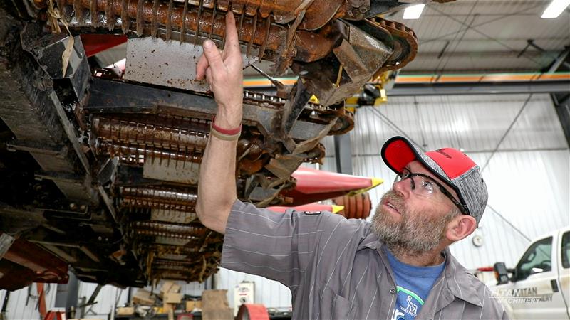 Service Tech with Header Titan Machinery Service Technician working on a corn header